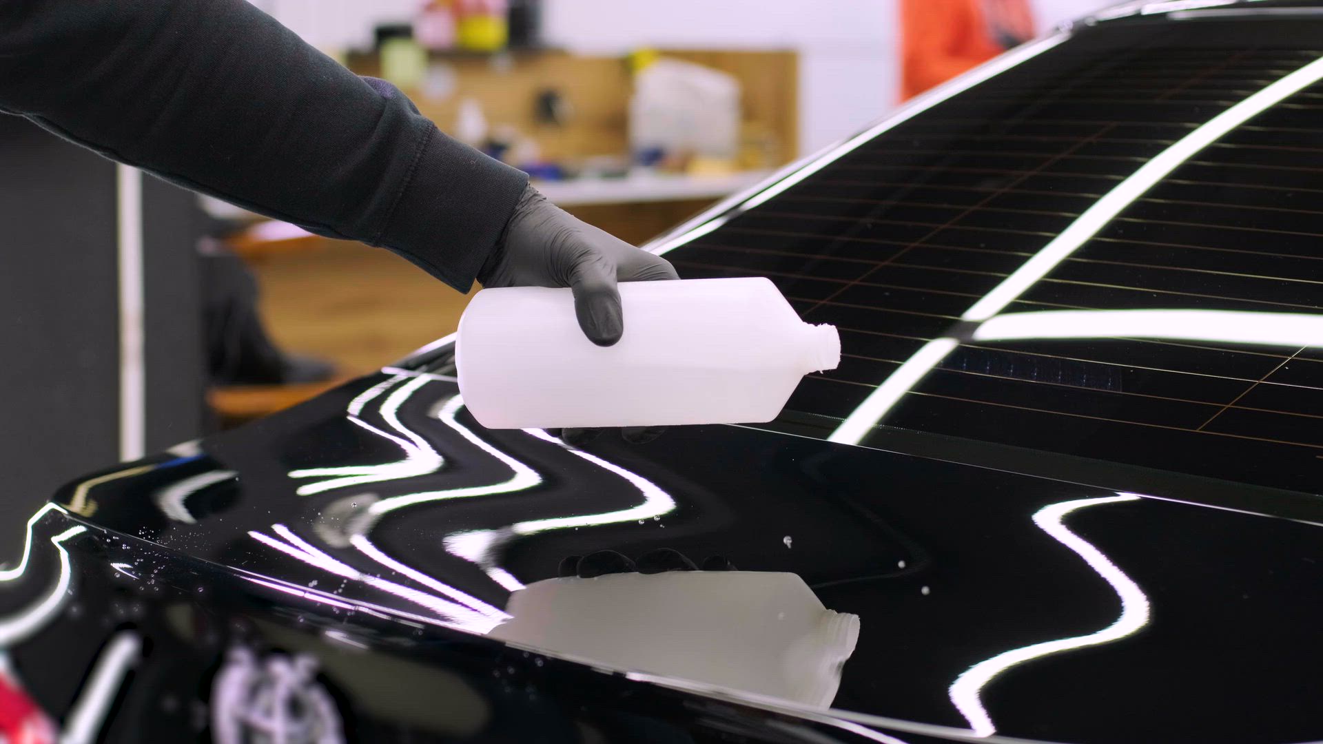 Water beading across a ceramic-coated paint surface