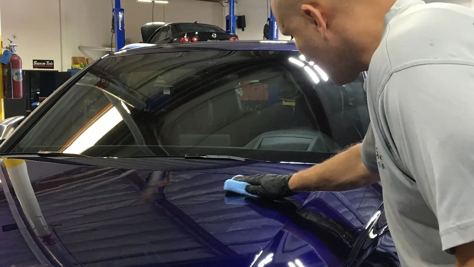 Certified installer hand-applying an XPEL ceramic coating