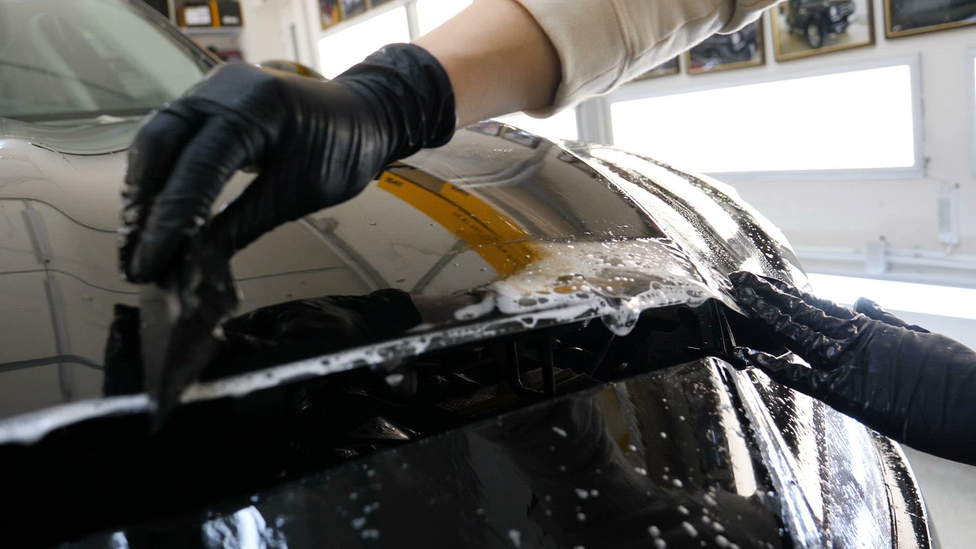 Paint protection film being installed on a vehicle panel